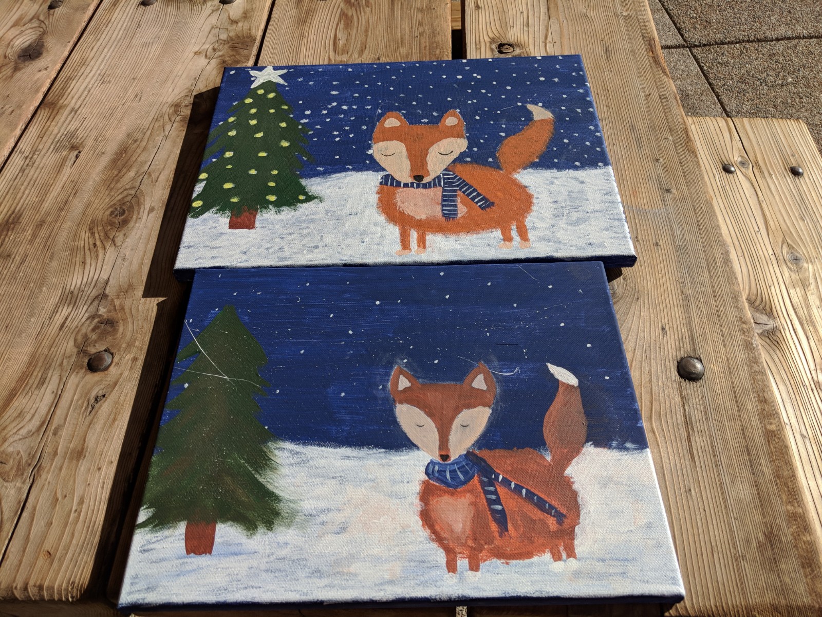 Two paintings of foxes in the snow