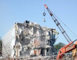 wrecking ball tearing down building