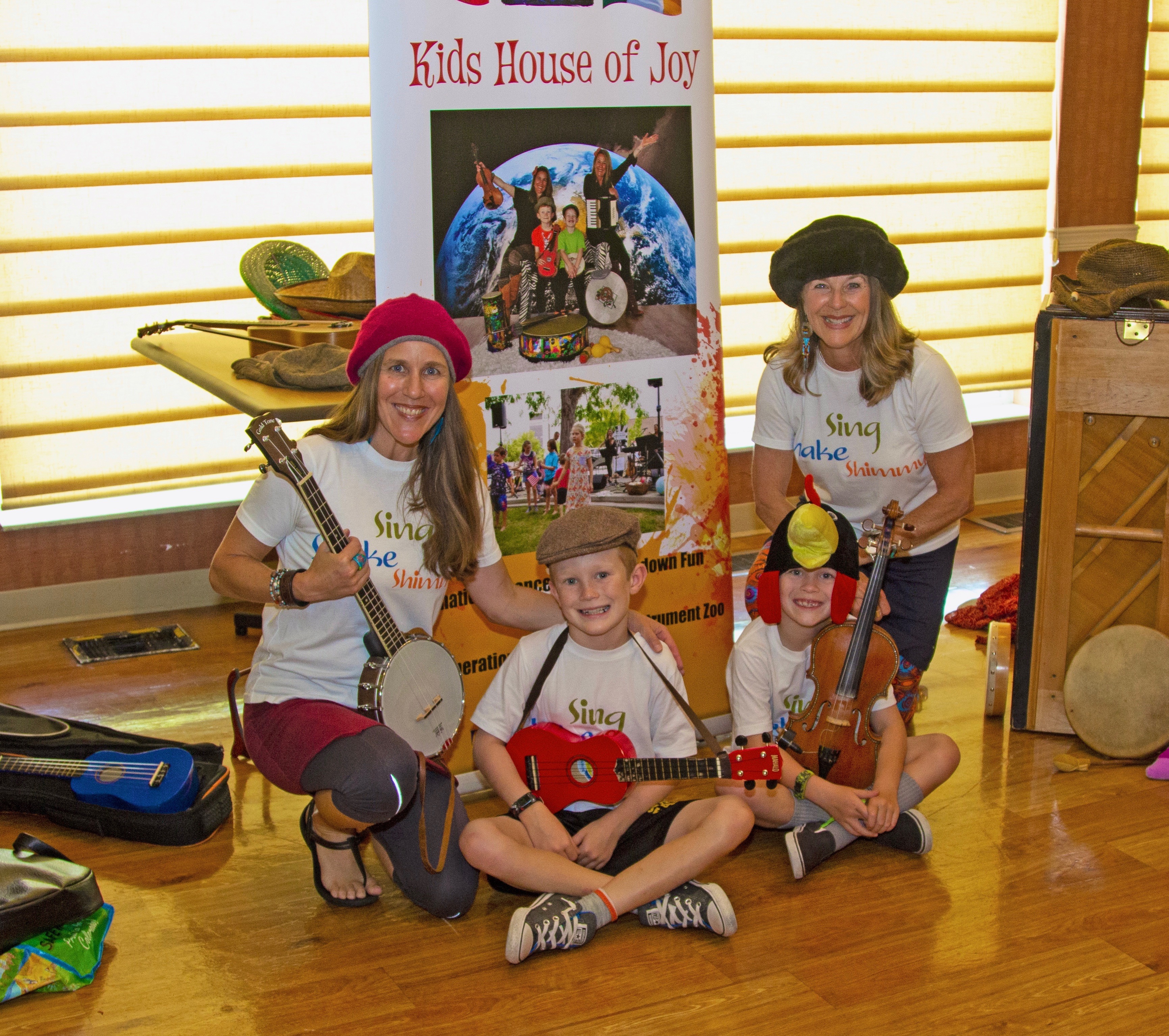 2 women and 2 kids each with an instrument