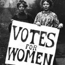 Historic photograph of women holding "votes for women" sign