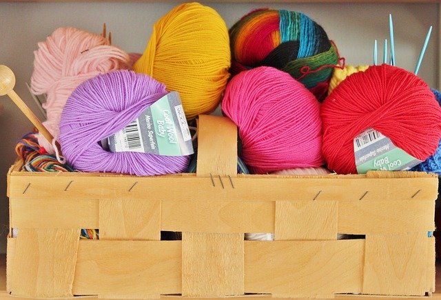 A basket of yarn and knitting needles