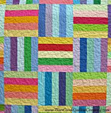 A quilt block made of colorful rainbow stripes set at perpendicular angles 