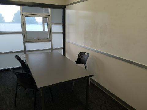 East Library Study Room E7 with table, three chairs, and a whiteboard