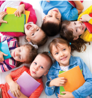 children in circle lying on their back holding books to their chest smiling