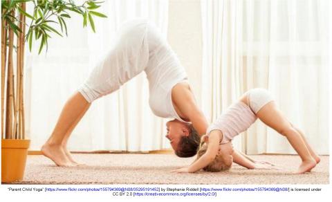 Adult and child practicing yoga together