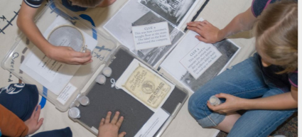 Kids working in a group over materials