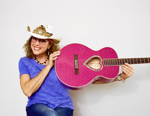 Musician holding pink guitar