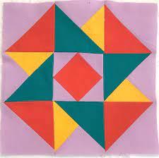 Colorful Air Castle quilt block made of red, yellow, green, and pink triangles