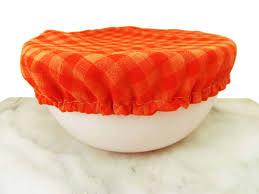 A white bowl with an orange fabric cover