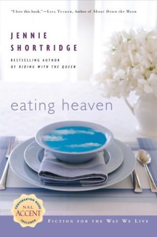 Cover of the book Eating Heaven by Jennie Shortridge. The cover shows a setup at a table covered in a small tablecloth with a plate that has a napkin, then a bowl on top of it. The bowl has an image of the sky, blue with clouds, inside of it. 