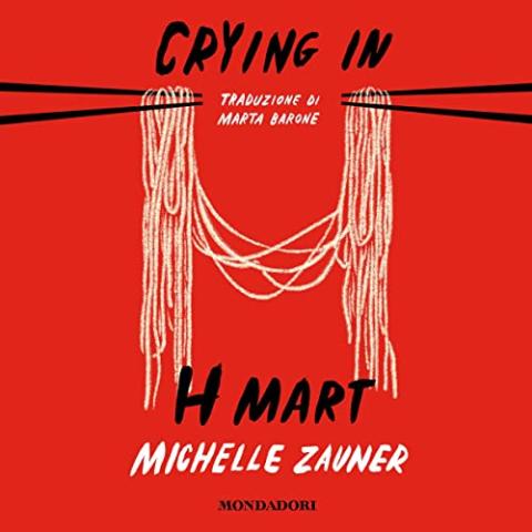 The cover of "Crying In H Mart: a memoir" by Michelle Zauner. It is solid red with a pair of black chopsticks holding noodles in the shape of an H.