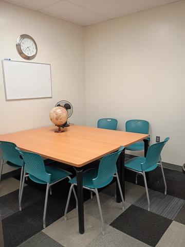 D1 study room with table, 6 chairs, and small whiteboard
