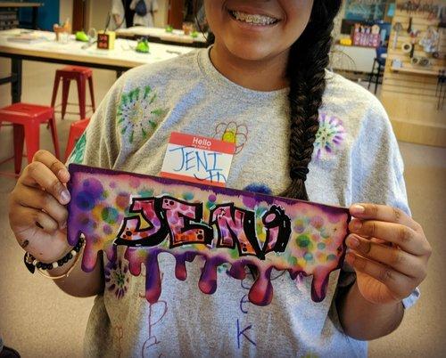 Teen posing with stylized nametag