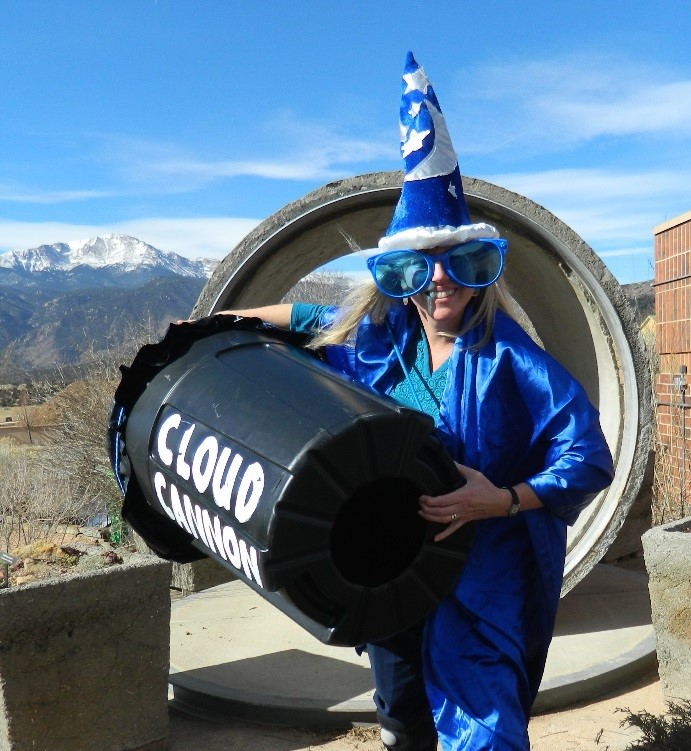 woman outdoors holding a canister with the word cloud