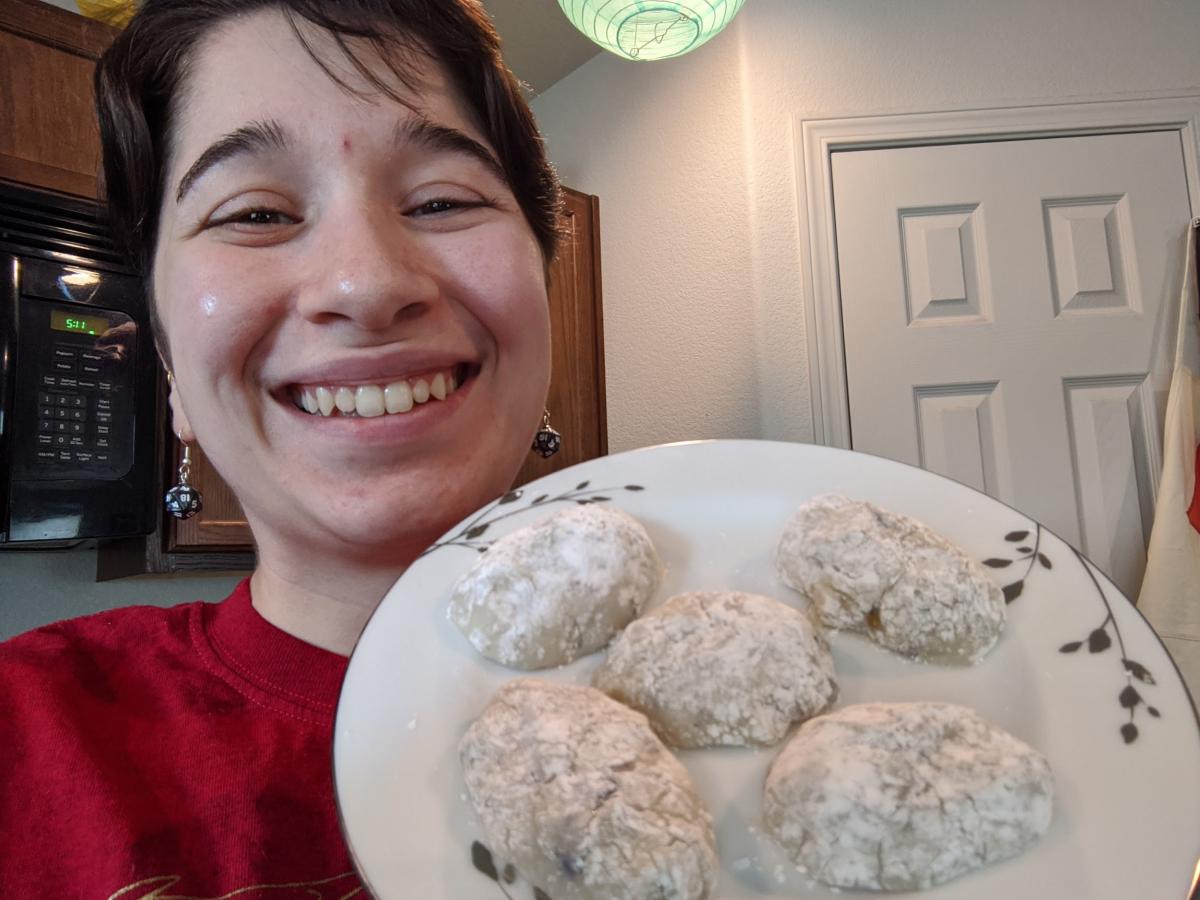 Picture of presenter holding up plate of truffles.