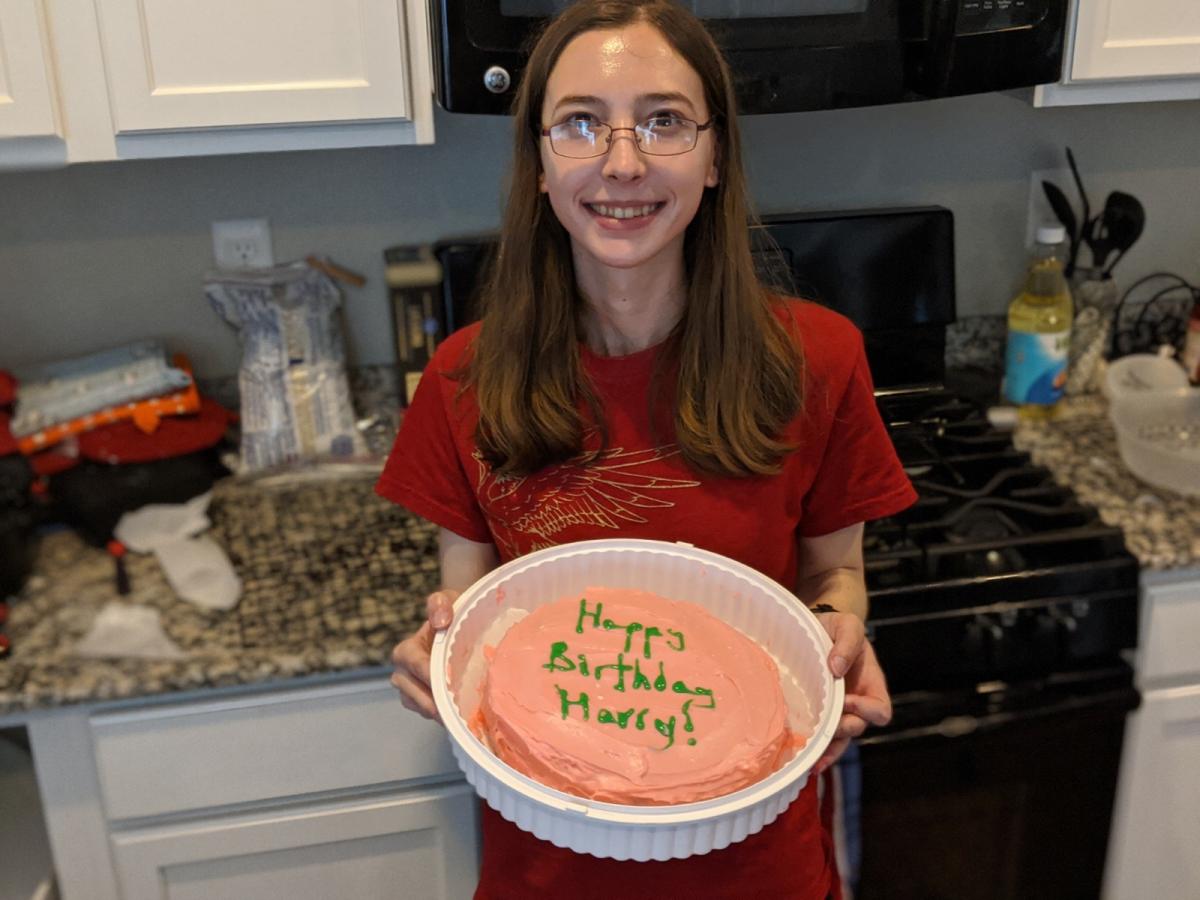 Image of presenter holding cake.